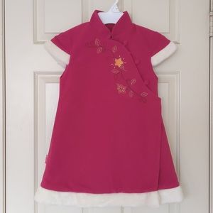 Girl's quilted long vest trimed with faux fur and embroidery.